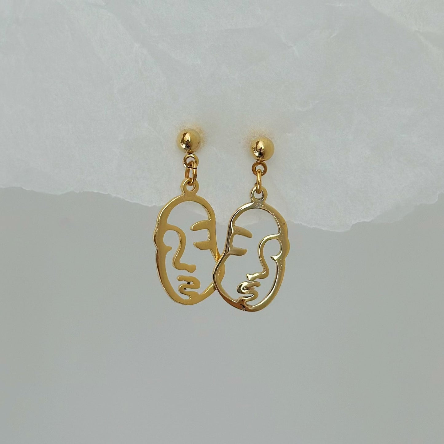 gold abstract face charm earrings