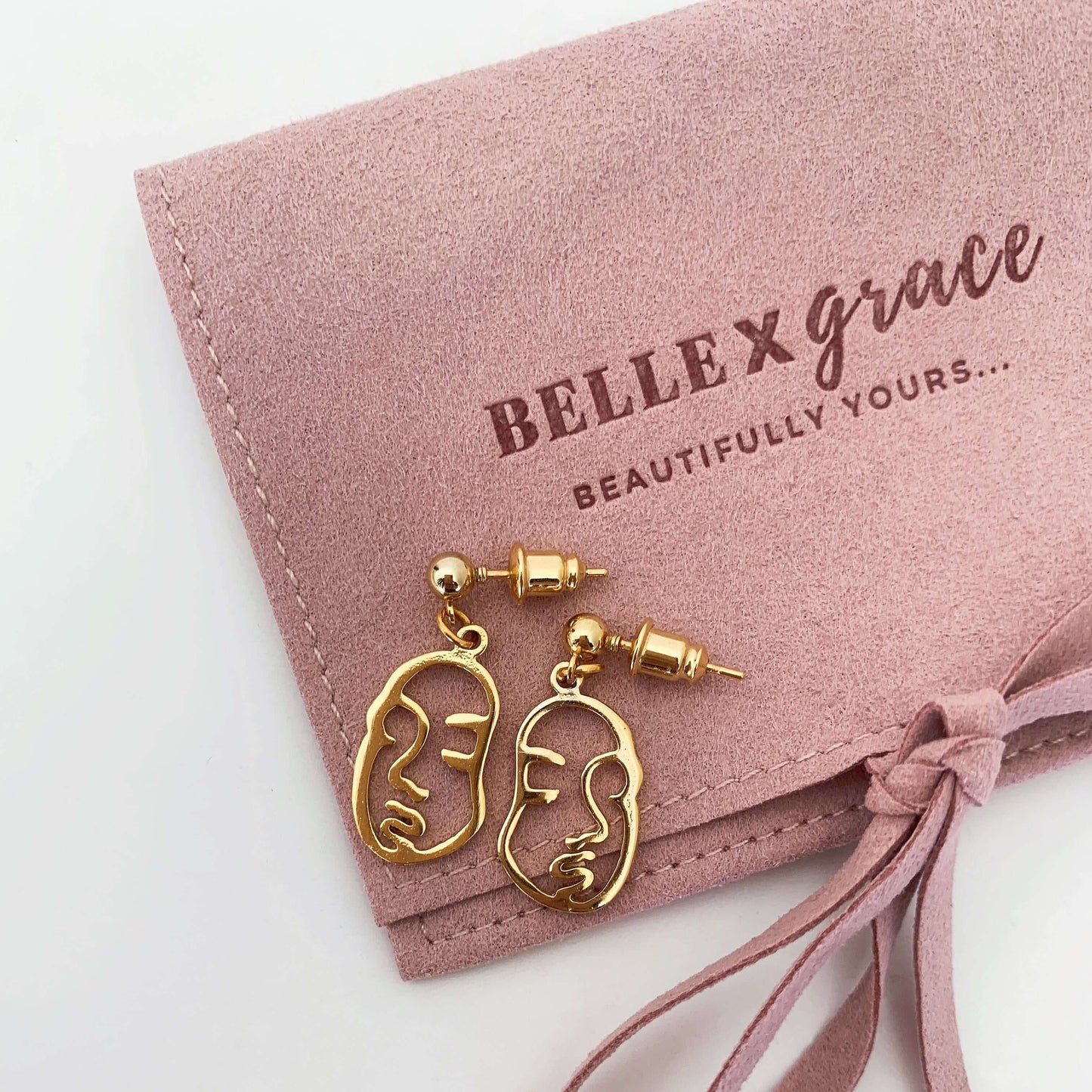 gold abstract face charm earrings