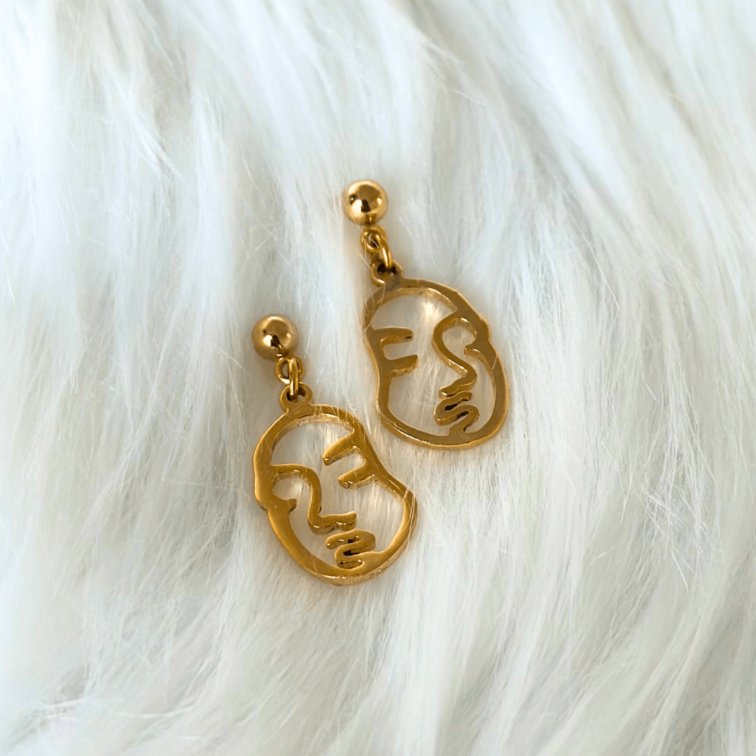 gold abstract face charm earrings