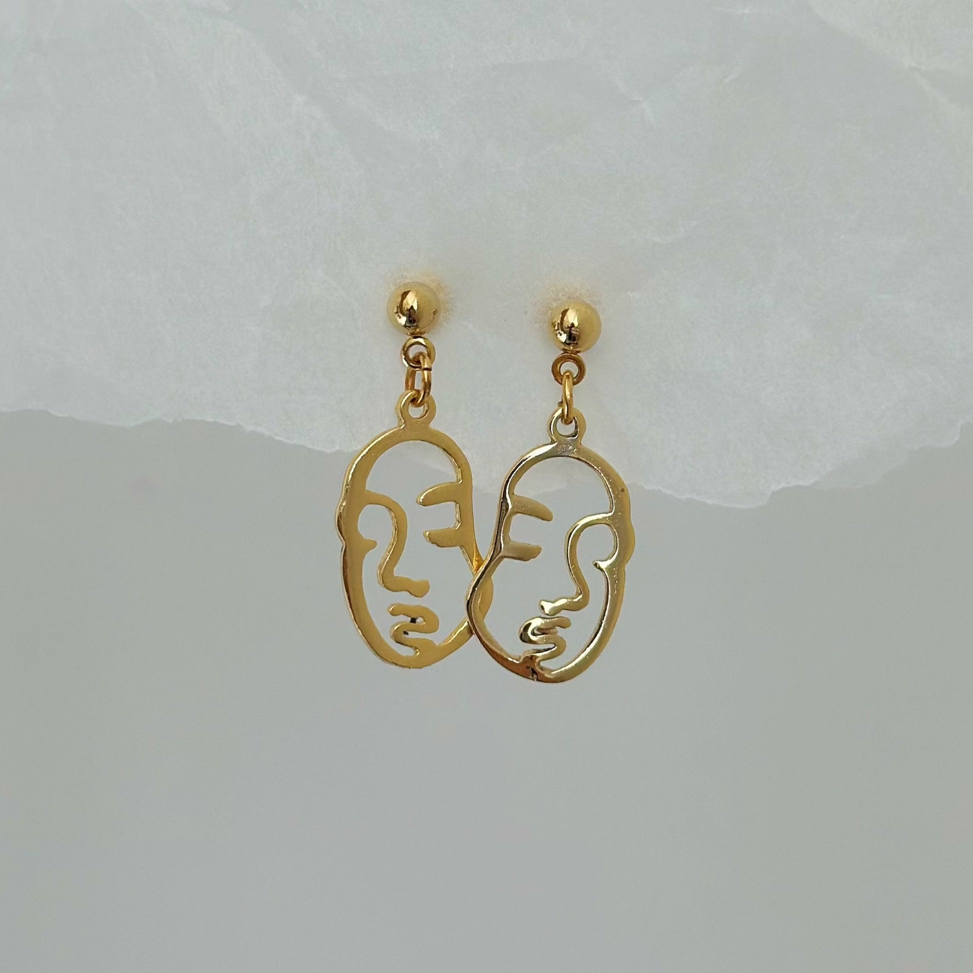 gold abstract face charm earrings